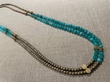 top view of gemstone bead necklace comprising aqua quartz, gold hematite and bronze hex accents.
