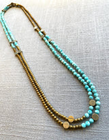 top view of gemstone bead necklace comprising aqua amazonite, gold hematite and bronze dot accents.