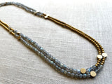 top view of gemstone bead necklace comprising grey labradorite, gold and silver hematite and bronze dot accents.