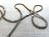 closeup view of gemstone bead necklace comprising grey labradorite, gold and silver hematite and bronze dot accents.