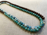 top view of gemstone bead necklace comprising blue azurite, green amazonite and brown exotic wood.