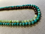 side view of gemstone bead necklace comprising green calcite, turquoise and brown exotic wood.