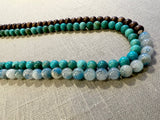side view of gemstone bead necklace comprising blue azurite, turquoise and brown exotic wood.