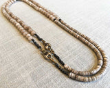 top view of gemstone bead necklace comprising taupe quartz, beige shell and sterling silver mariners link