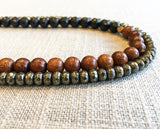 side view of gemstone bead necklace comprising black onyx, dark grey pyrite and exotic wood