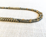 side view of gemstone bead necklace comprising metallics