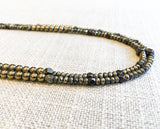 side view of gemstone bead necklace comprising metallics