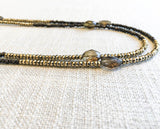 side view of gemstone bead necklace comprising metallics and smoky quartz