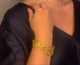 model wearing organic-shaped gold bracelet