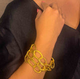 model wearing organic-shaped gold bracelet