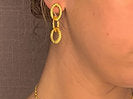 model wearing organic-shaped gold earrings