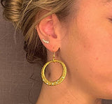 model wearing organic-shaped gold earrings