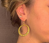 model wearing organic-shaped gold earrings