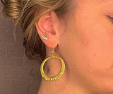 model wearing organic-shaped gold earrings