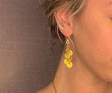 model wearing organic-shaped gold earrings