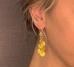 model wearing organic-shaped gold earrings