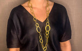 model wearing organic-shaped gold necklace