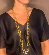 model wearing organic-shaped gold necklace