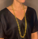 model wearing organic-shaped gold necklace