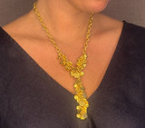 model wearing organic-shaped gold necklace