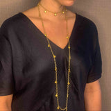 model wearing organic-shaped gold necklace