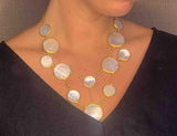 model wearing organic-shaped gold necklace