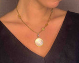 model wearing organic-shaped gold necklace