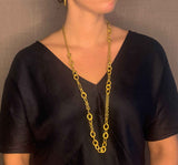 model wearing organic-shaped gold necklace