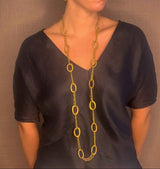 model wearing organic-shaped gold necklace