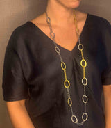 model wearing organic-shaped gold and silver necklace