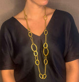 model wearing organic-shaped gold necklace