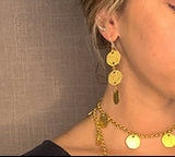 model wearing organic-shaped gold earrings