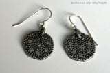 top view of organic-shaped silver earrings