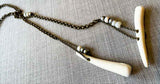 closeup of antler lariat on large bronze rolo chain