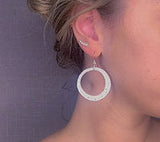 model wearing organic-shaped silver earrings