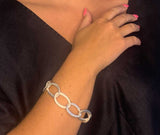 model wearing organic-shaped silver bracelet