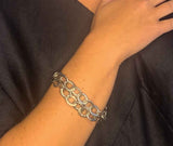 model wearing organic-shaped silver bracelet