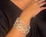 model wearing organic-shaped silver bracelet