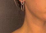 model wearing organic-shaped silver earrings