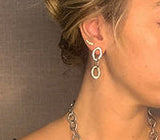 model wearing organic-shaped silver earrings