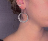 model wearing organic-shaped silver earrings