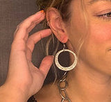 model wearing organic-shaped silver earrings