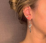 model wearing organic-shaped silver earrings