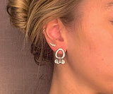model wearing organic-shaped silver earrings