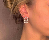 model wearing organic-shaped silver earrings