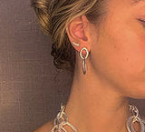 model wearing organic-shaped silver earrings