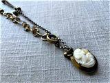 side view of antique carved cameo locket pendant on chain mix