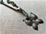 side view of antique butterfly pendant on chain mix
