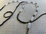 closeup view of gemstone bead necklace comprising clear natural quartz, golden pyrite and dark bronze.