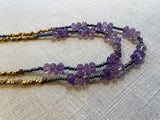 side view of gemstone bead necklace comprising purple amethyst, grey pyrite and bronze.